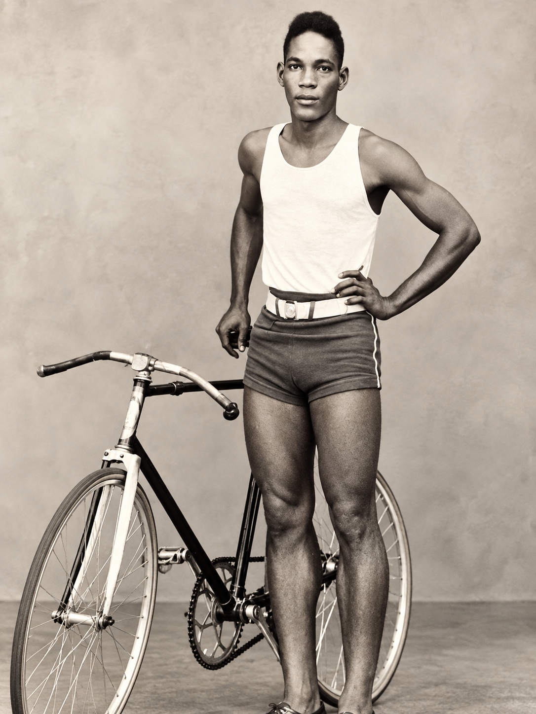 Frederick ‘Uncle Fred’ Anderson standing beside a bicycle